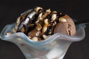 chocolate ice cream with peanuts, caramel and chocolate photo