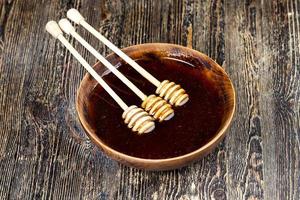 thick and sweet buckwheat honey of dark red color photo