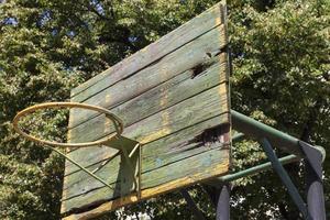 an old basketball ring in the yard photo