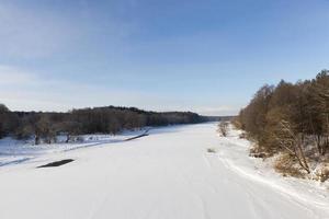 river covered with ice and snow photo
