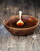 natural honey in a large wooden bowl photo