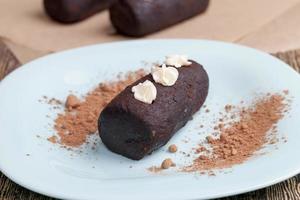 cake is covered with a layer of powdered sugar with cocoa photo