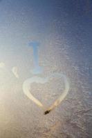 heart painted on a window in winter photo