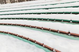 stadium seats covered with snow in winter photo