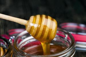 dipped in honey specially made from wood homemade coarse spoon photo