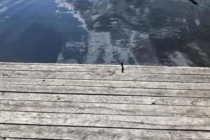 a wooden pier by the lake photo