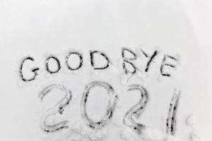 the inscription about the new year 2022 on the snow in winter photo