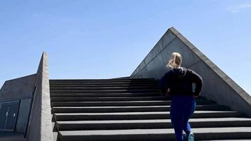 attraktive junge frau, die in zeitlupe treppen hochläuft, stock footage von brian holm nielsen video