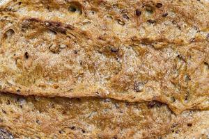 oval loaf of dark bread made from several types of flour photo