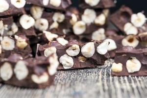 delicious milk homemade chocolate with lots of hazelnuts photo