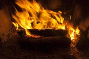burning logs in the fire of a barbecue or stove or fireplace photo