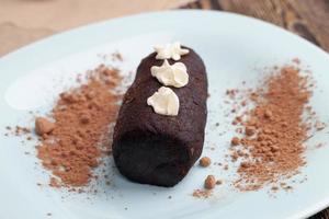 cake is covered with a layer of powdered sugar with cocoa photo