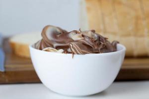 sliced white bread with sweet chocolate butter spread photo