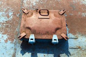 part of a metal structure with a rusty surface and hatches photo