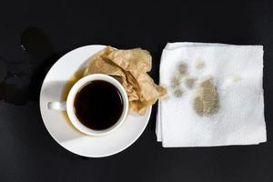 black aromatic coffee spilled due to carelessness photo