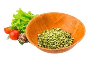 Dry green peas in a bowl on white background photo