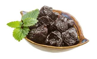 Dried plums in a bowl on white background photo