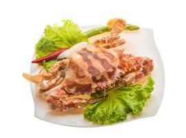 Red crab on the plate and white background photo