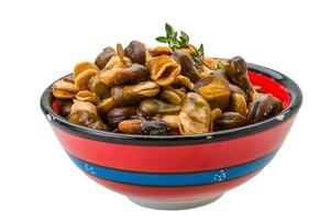 Broad beans in a bowl on white background photo