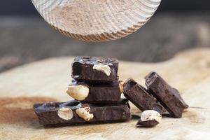 divided into parts chocolate bar with whole nuts photo
