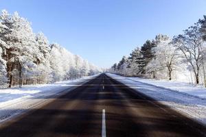 snowfall in the winter season and road asphalted photo