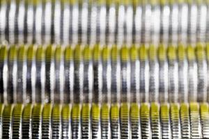 many round metal coins of silver color illuminated in yellow photo