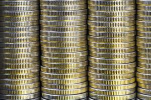 many round metal coins of silver color illuminated with Golden color photo