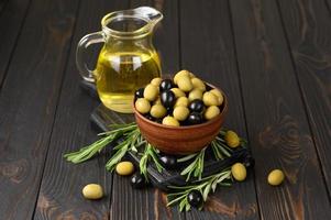 Black and green olives on a dark wooden rustic background. photo