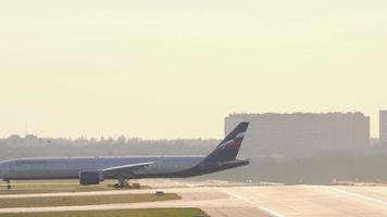 MOSCOW, RUSSIAN FEDERATION SEPTEMBER 13, 2020 - Aeroflot Russian Airlines Boeing 777 taxiing to terminal after landing at Sheremetyevo International airport, SVO UUEE, gleaming in the morning sun. video