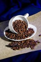 The inverted cup with coffee beans photo