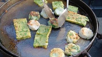 Frying Chinese Chives dessert in pan, street food Thailand video