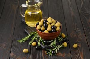 Black and green olives on a dark wooden rustic background. photo