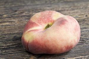 a ripe flat peach photo