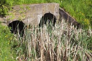 water flowing from the city sewer photo