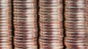 many round metal coins of silver color illuminated in red photo