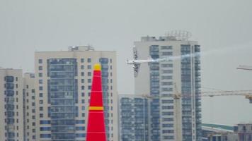 KAZAN, RUSSIAN FEDERATION, JUNE 14, 2019 - Sports light engine aircraft performs extreme spectacular stunts in the air at the Red Bull Air air show in Kazan video