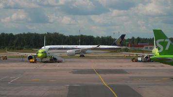 MOSCOW, RUSSIAN FEDERATION JULY 24, 2021 - Civil airplane of S7 Airlines taxiing to the terminal at Domodedovo airport. Aviation Traffic. Singapore Airlines plane at the airport video