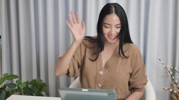 Asians use laptop computers to make video calls. meeting with friends