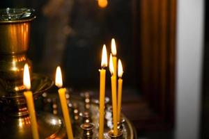 Lighted candles on  church photo