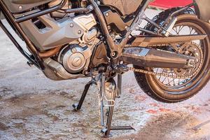 A clean wet motorcycle of the enduro class. Car wash. Wet bike. photo