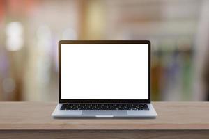 Modern Laptop computer with blank screen on wood table over blur bokeh light background. photo