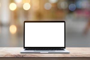 Modern Laptop computer with blank screen on wood table over blur bokeh light background. photo