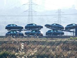 traffic on the highway and high voltage pylons in the background photo