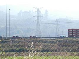 traffic on the highway and high voltage pylons in the background photo