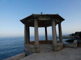 Classical stone traffic circle in front of the sea on the coastal path of S'Agaro, Catalonia, Spain photo