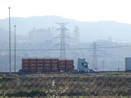 traffic on the highway and high voltage pylons in the background photo