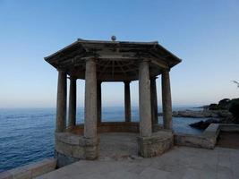 Classical stone traffic circle in front of the sea on the coastal path of S'Agaro, Catalonia, Spain photo