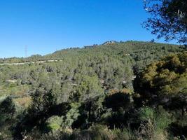 Collcerola mountain range very close to the city of Barcelona and in the background a cement factory with no activity. photo