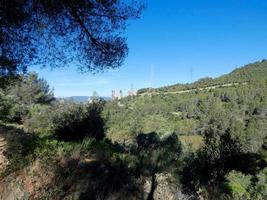 Collcerola mountain range very close to the city of Barcelona and in the background a cement factory with no activity. photo