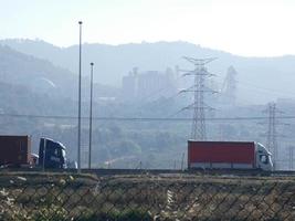 traffic on the highway and high voltage pylons in the background photo